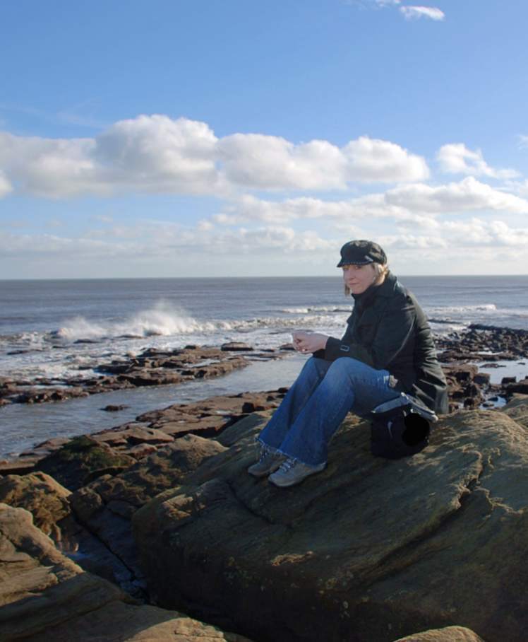 Artist Karen M Berisford on the shoreline at Newbiggin by the Sea, Northumberland, UK