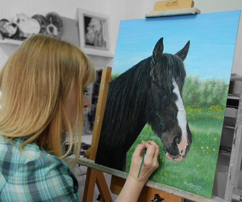 artist Karen in the studio painting a dark bay horse portrait