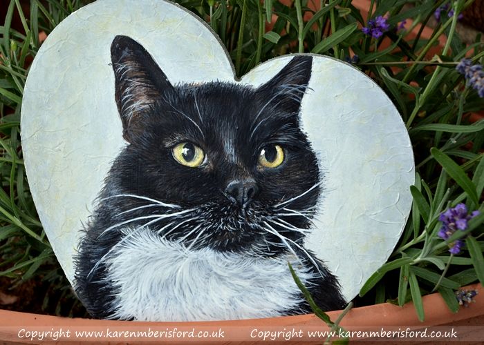 Black and white british shorthaired cat painted in acrylic paints on an MDF heart