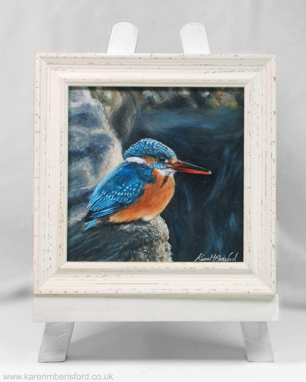 Acrylic painting in an ivory frame depicting a female Kingfisher upon a rock on the beach at Newbiggin by the Sea, Northumberland, UK