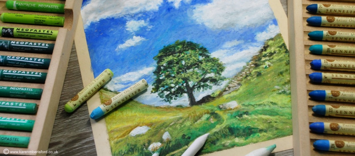 Oil pastel painting of the Sycamore Gap tree in Northumberland and Sennelier and Neopastel oil pastel sticks in wooden drawers